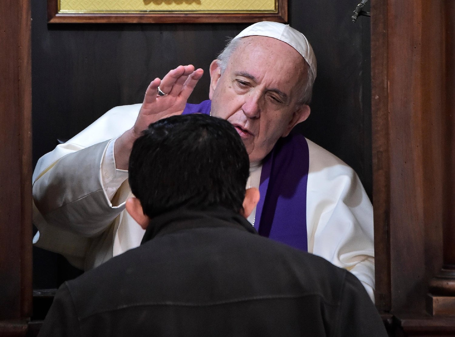 Pope Francis hears the confession of a priest at the Basilica of St. John Lateran in Rome in this March 7, 2019, file photo.